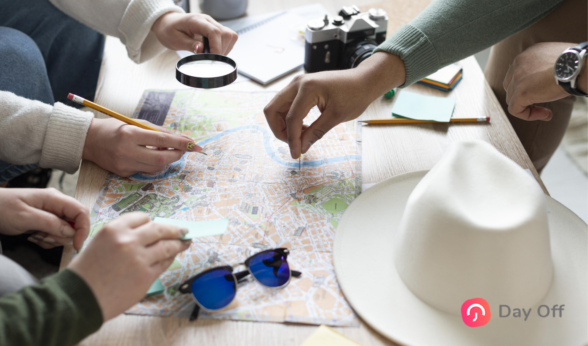 A group of people pointing hands at a world map