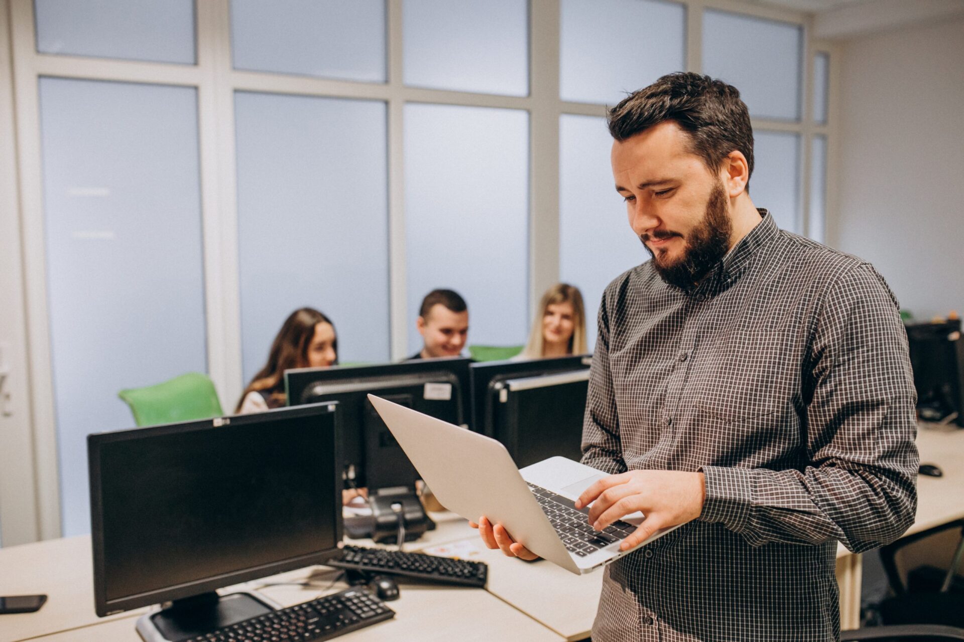 An image of an employee holding his laptop