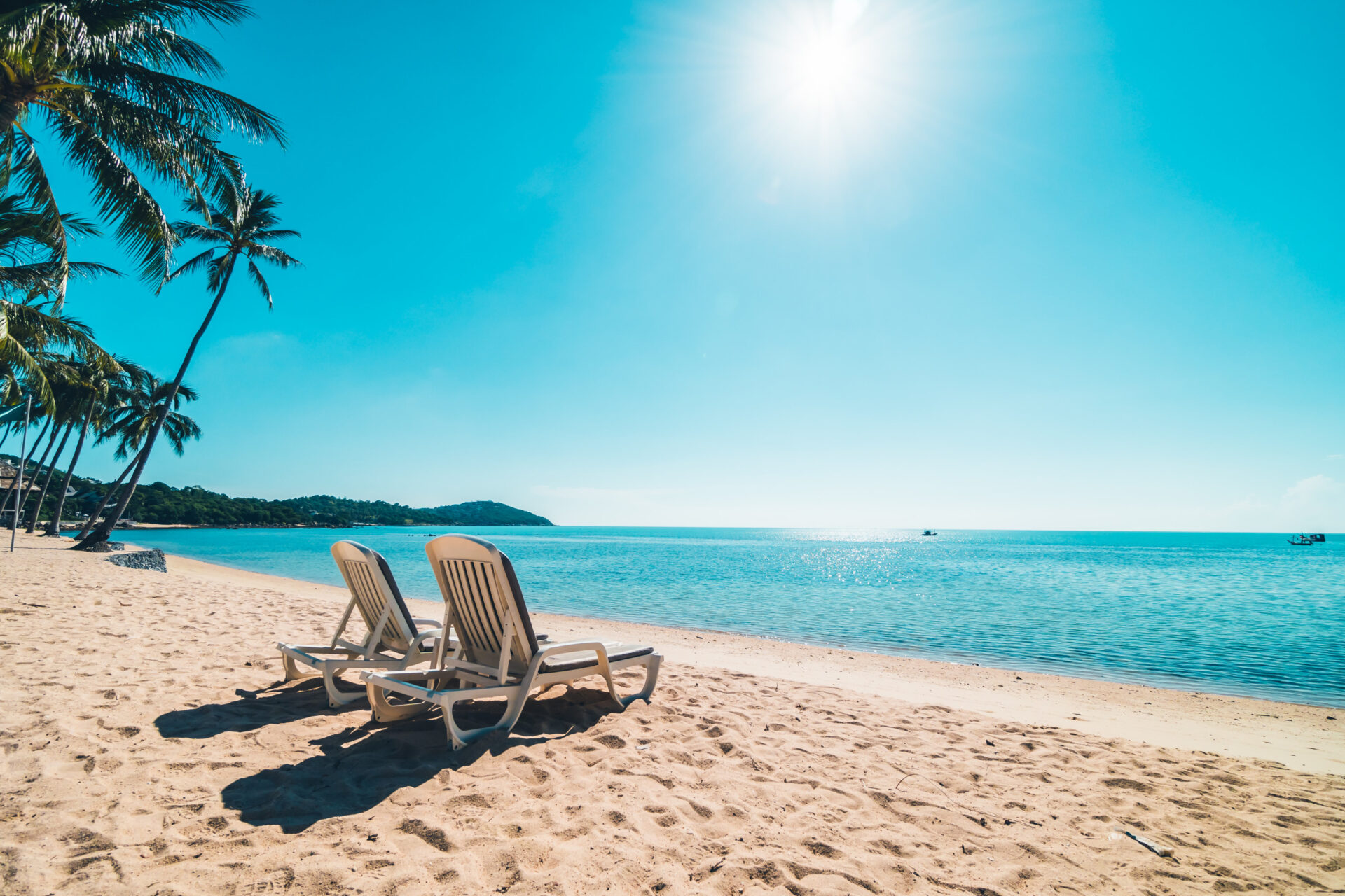 A n image of beautiful tropical beach sea with chair and clear blue sky