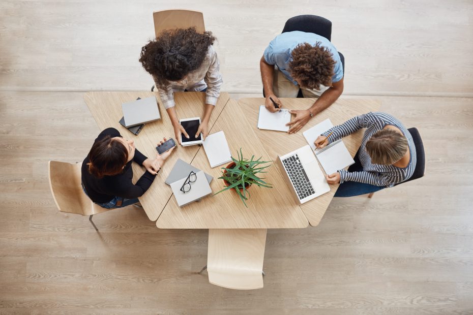 view-from-business-startup-teamwork-concept-startup-partners-sitting-coworking-space-talking-about-future-project-looking-through-examples-work-laptop-digital-tablet-