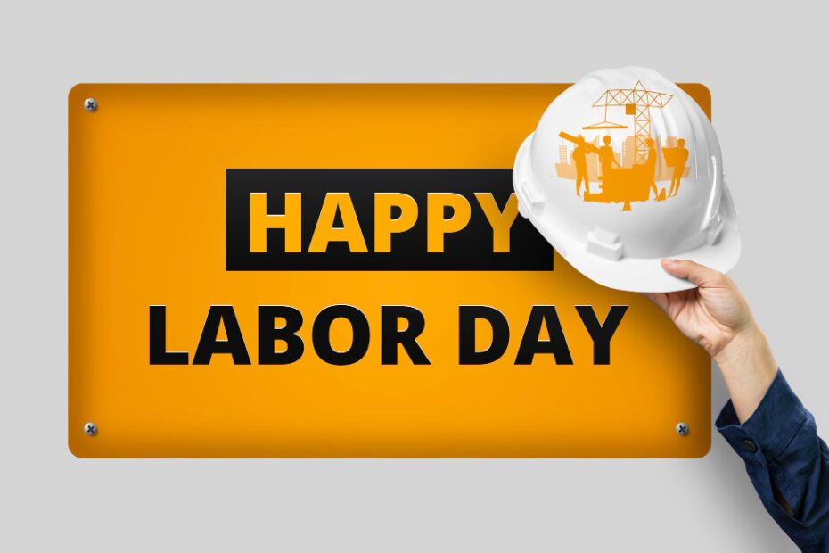 An image of a hand holding a helmet with a banner written on to Happy labor day