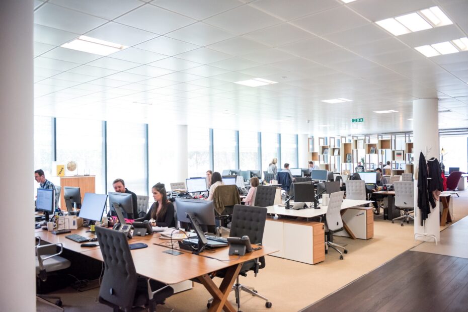 An image of a huge modern office filled with numbers of discs and workers