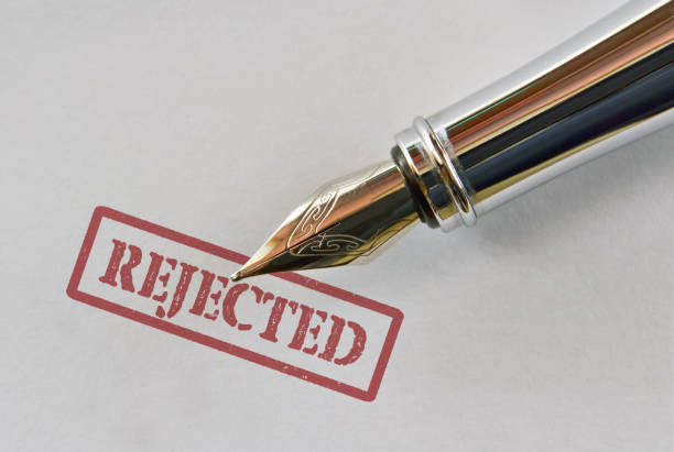 Closeup of a fountain pen and word Rejected on bright background