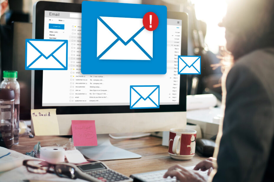 An image of employee sitting in front of his laptop and icons of coming emails are pooping from the screen.