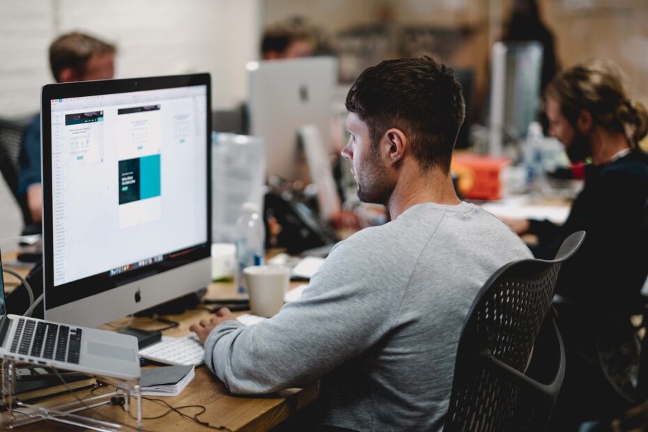 An image of a man looking straight at his digital screen.