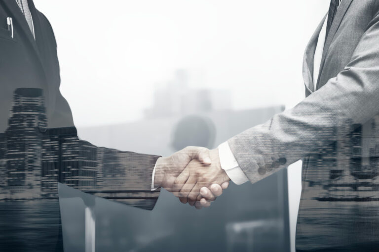 An image of two employee shaking hands