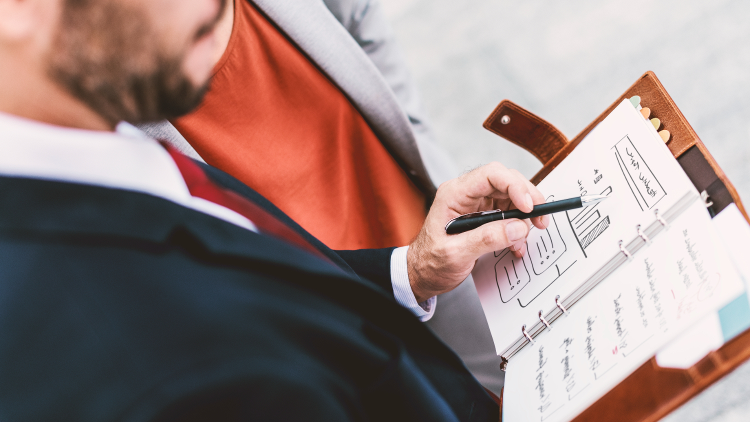 an employee holding a ben to mark some thing in his individual development plan.